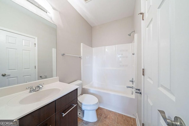 bathroom with tub / shower combination, toilet, and vanity