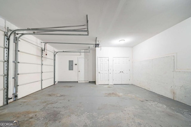 garage featuring electric panel and a garage door opener