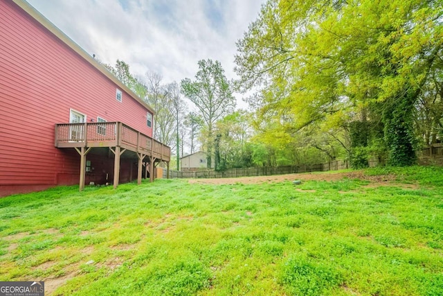 view of yard featuring fence and a wooden deck