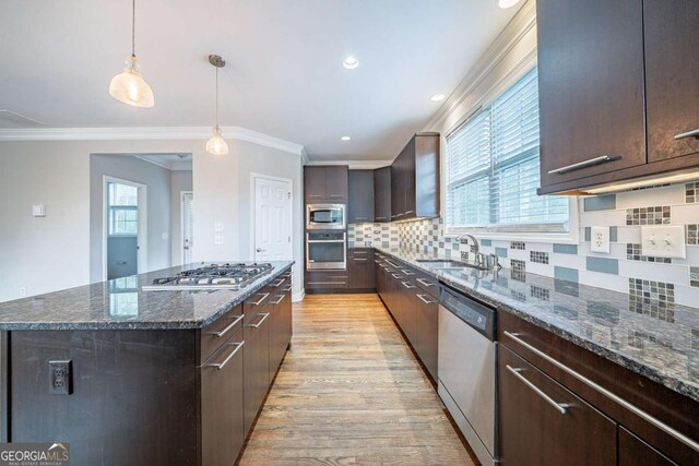 4915 Wycliffe Dr, Stone Mountain, GA 30087 - kitchen with stainless steel appliances, dark brown cabinetry, light wood-style flooring, crown molding, and recessed lighting