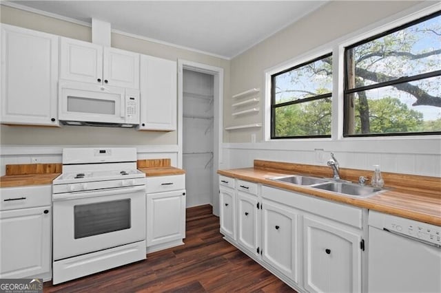 kitchen with white appliances, white cabinets, dark wood-style flooring, a sink, and butcher block countertops
