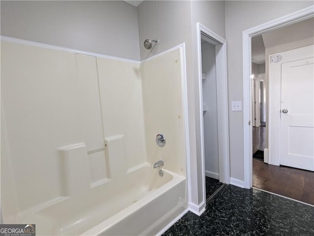 full bathroom with  shower combination and baseboards
