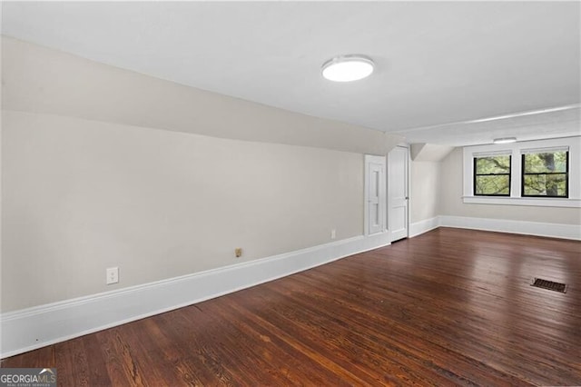 bonus room featuring visible vents, baseboards, and wood finished floors