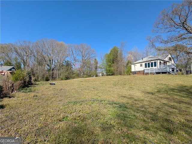 view of yard featuring a wooden deck