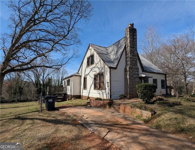 view of home's exterior with a yard and a chimney