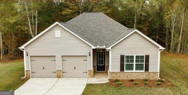 120 Chapman Ridge Rd, Macon, GA 31211 - view of front of property featuring brick siding, an attached garage, a front yard, concrete driveway, and roof with shingles