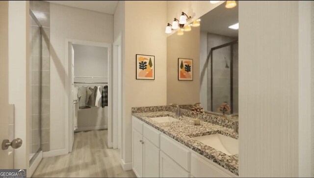120 Chapman Ridge Rd, Macon, GA 31211 - bathroom with a shower stall, a walk in closet, double vanity, wood finished floors, and baseboards