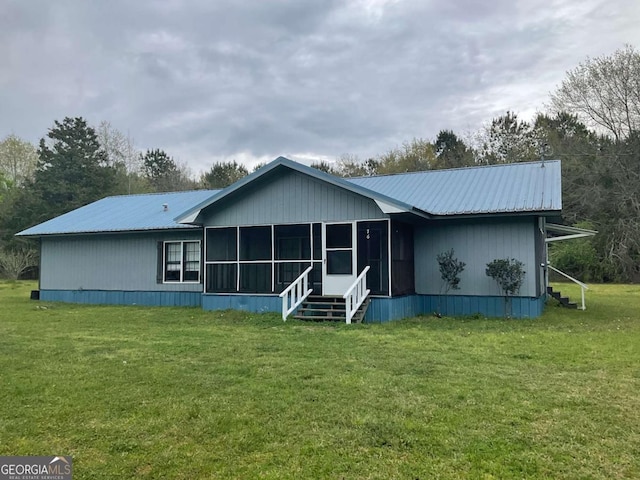 76 Jacqueline Dr, Georgetown, GA 39854 - view of front of property with a sunroom, a metal roof, and a front lawn