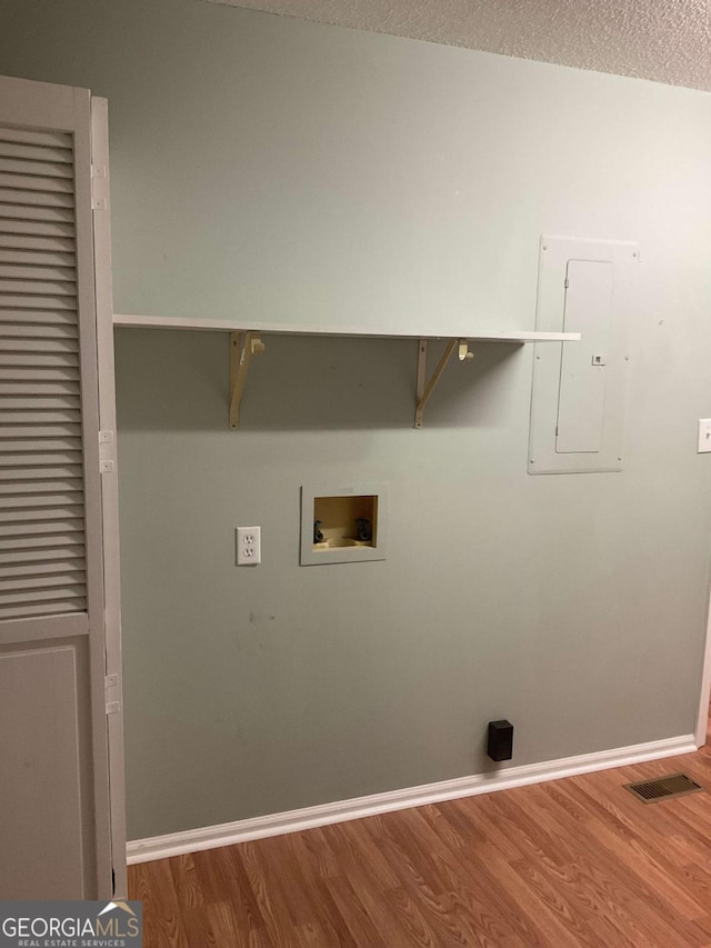 76 Jacqueline Dr, Georgetown, GA 39854 - laundry room featuring washer hookup, electric panel, wood finished floors, and a textured ceiling