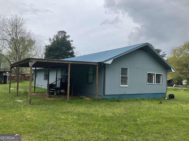 76 Jacqueline Dr, Georgetown, GA 39854 - rear view of house with a lawn and a metal roof