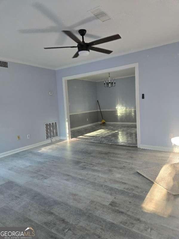 garage with baseboards, ceiling fan, and visible vents