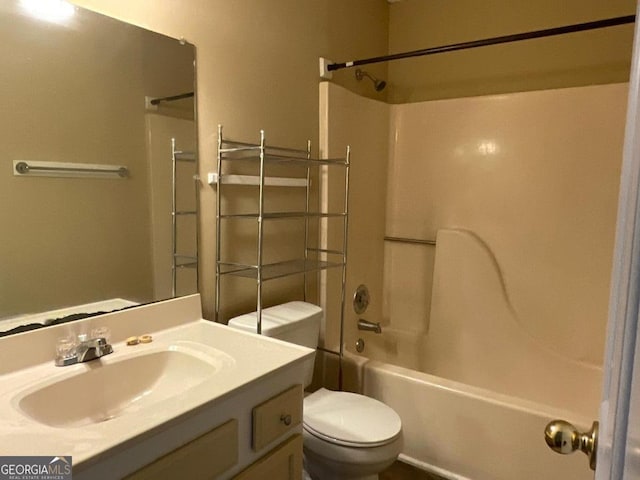 full bath featuring toilet, vanity, and bathing tub / shower combination