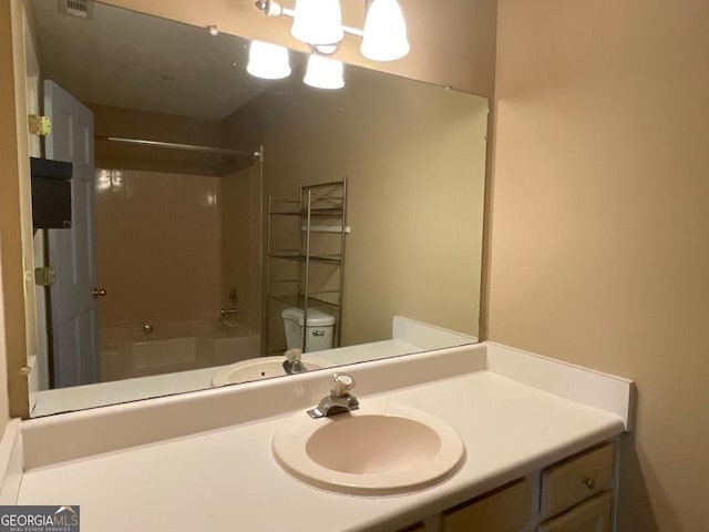 bathroom featuring shower / bathing tub combination, a chandelier, toilet, and vanity