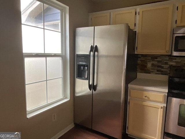 kitchen with stainless steel appliances, light countertops, and decorative backsplash