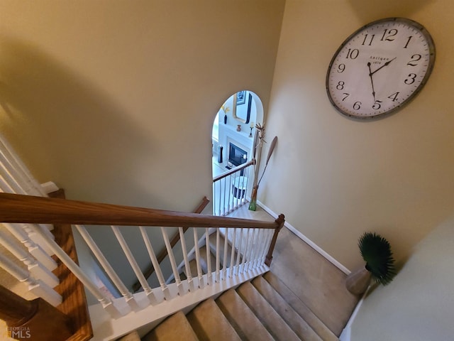stairs with baseboards and wood finished floors