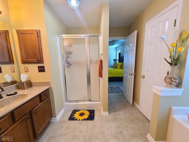 bathroom with tile patterned flooring, vanity, a stall shower, and a garden tub