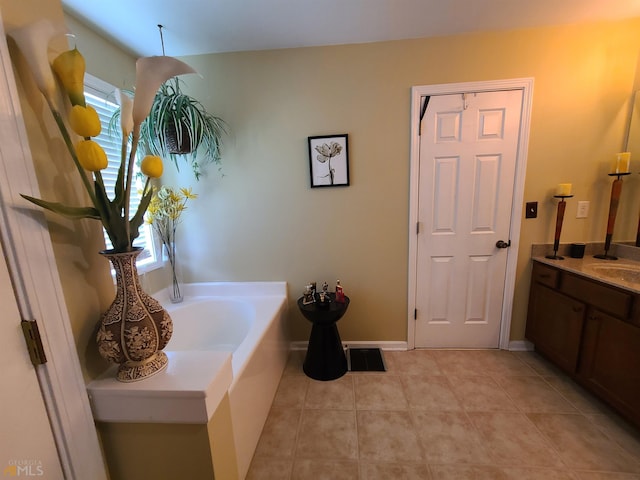 full bath featuring a bath, baseboards, tile patterned flooring, and vanity