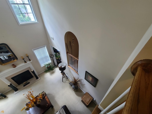 living room with stairs, a towering ceiling, and visible vents