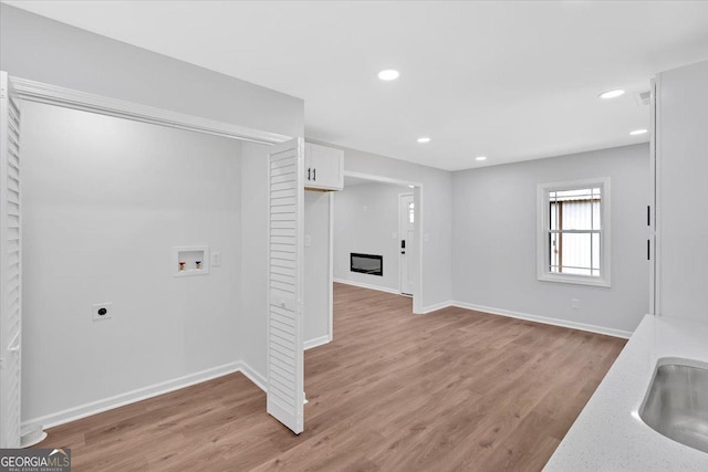 clothes washing area featuring washer hookup, laundry area, recessed lighting, hookup for an electric dryer, and light wood finished floors