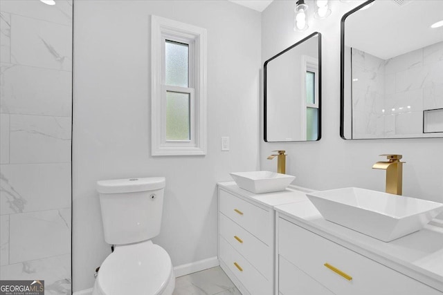 bathroom with baseboards, marble finish floor, a sink, and toilet