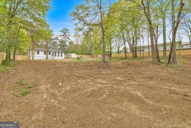 view of yard featuring an outbuilding and fence
