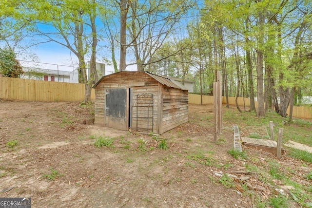 view of shed with fence