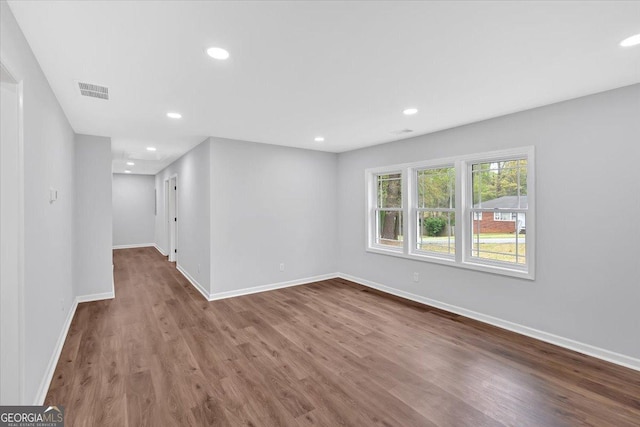 unfurnished room with visible vents, baseboards, recessed lighting, and wood finished floors