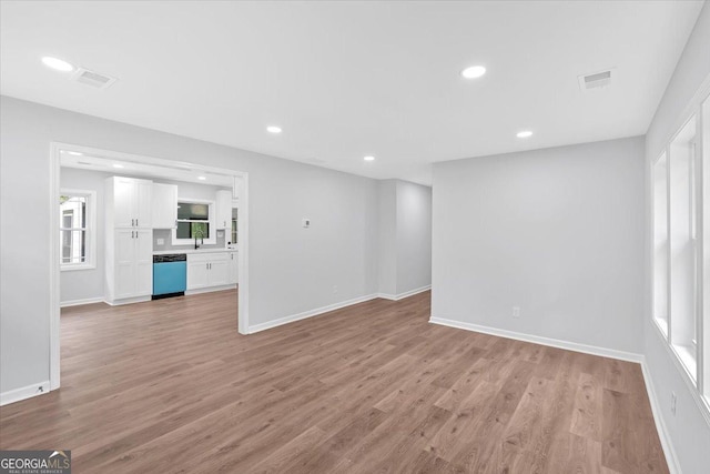 unfurnished living room with light wood-style floors, visible vents, and recessed lighting