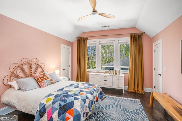 bedroom with dark wood-type flooring, visible vents, baseboards, and vaulted ceiling