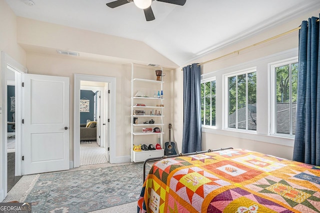 bedroom featuring visible vents, multiple windows, and vaulted ceiling