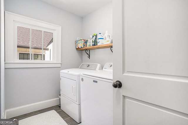 washroom featuring baseboards, independent washer and dryer, and laundry area