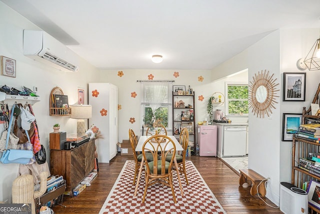 dining space with a wall mounted AC and dark wood finished floors