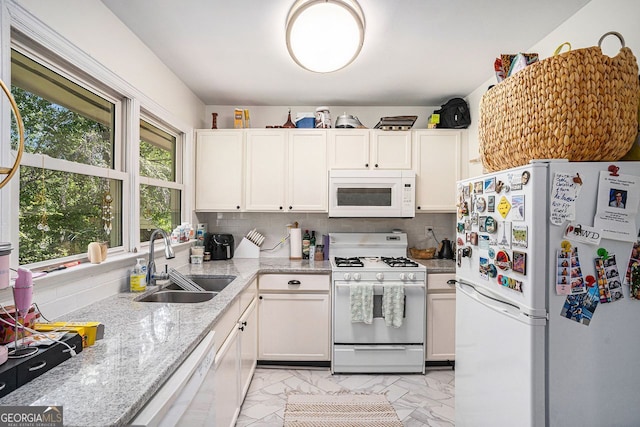 kitchen featuring a sink, tasteful backsplash, white appliances, and marble finish floor