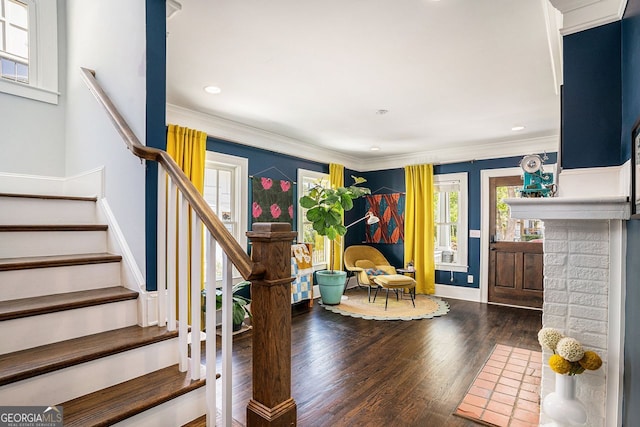 entryway with ornamental molding, recessed lighting, stairway, wood finished floors, and baseboards