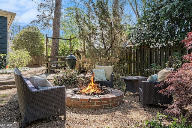 view of patio with a fire pit and fence
