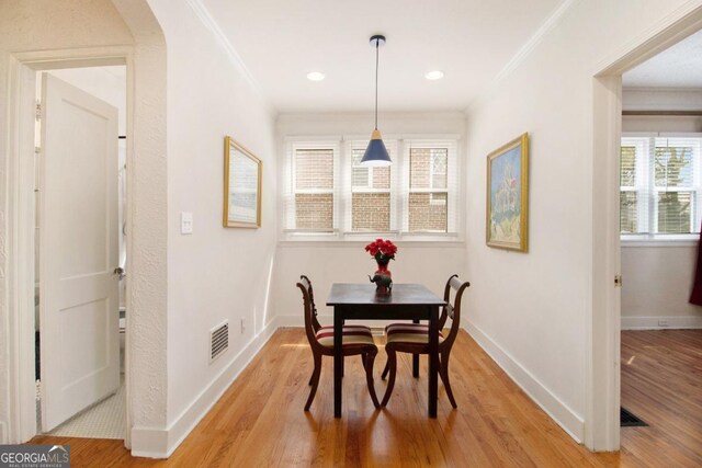 650 Somerset Ter NE, Atlanta, GA 30306 - dining room with light wood finished floors, visible vents, baseboards, and crown molding