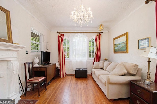 650 Somerset Ter NE, Atlanta, GA 30306 - living area with a textured ceiling, plenty of natural light, wood finished floors, a chandelier, and ornamental molding