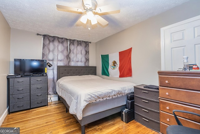 310 Austin Rd, Newnan, GA 30263 - bedroom featuring light wood finished floors, a textured ceiling, and ceiling fan