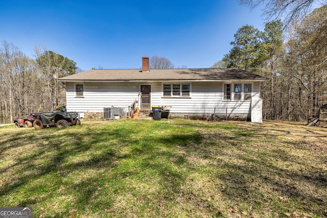 310 Austin Rd, Newnan, GA 30263 - rear view of property featuring a chimney, a lawn, crawl space, cooling unit, and entry steps