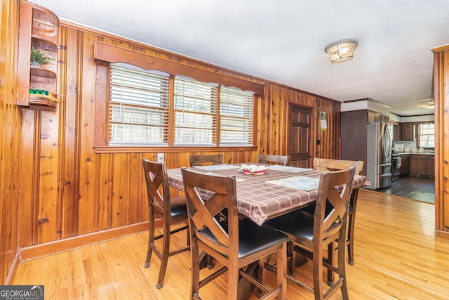 310 Austin Rd, Newnan, GA 30263 - dining space with wood finished floors, wooden walls, and crown molding
