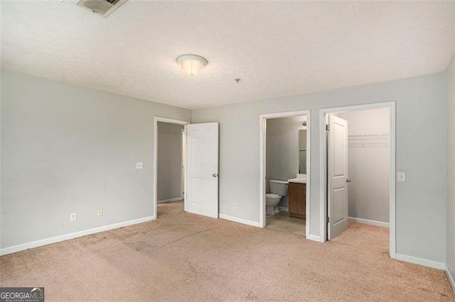 13304 Waldrop Cv, Decatur, GA 30034 - unfurnished bedroom featuring a walk in closet, baseboards, visible vents, and carpet flooring
