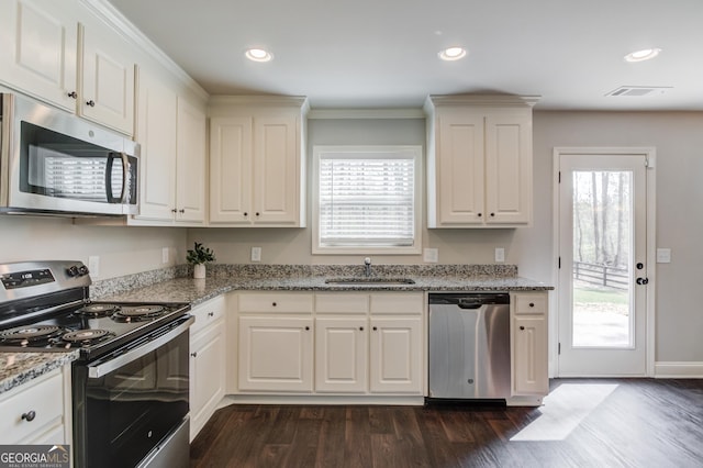 kitchen featuring dark wood-style flooring, white cabinets, visible vents, recessed lighting, and appliances with stainless steel finishes