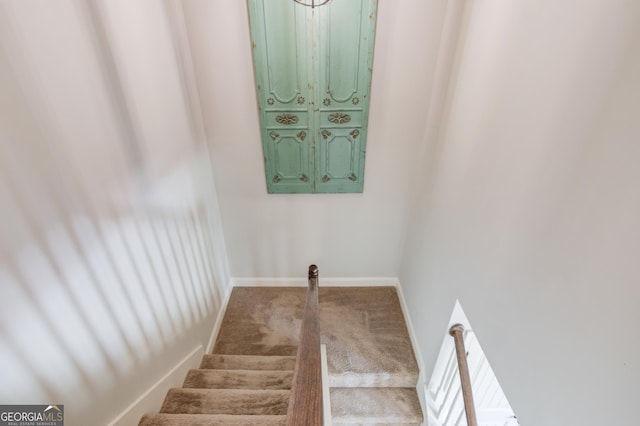 stairs featuring baseboards and carpet floors