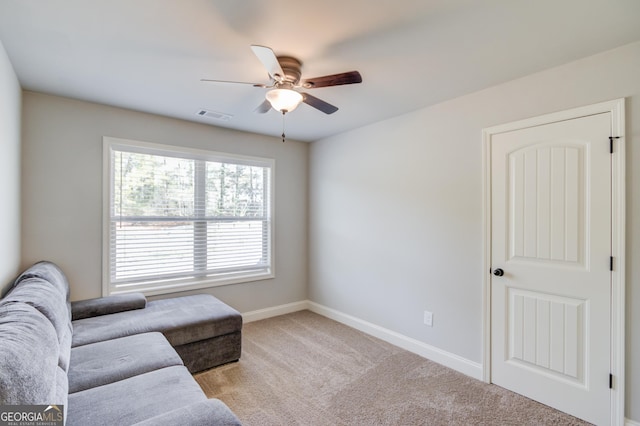 carpeted living room featuring a ceiling fan, baseboards, and visible vents
