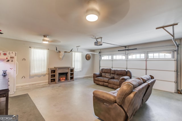 garage with a garage door opener, baseboards, and freestanding refrigerator