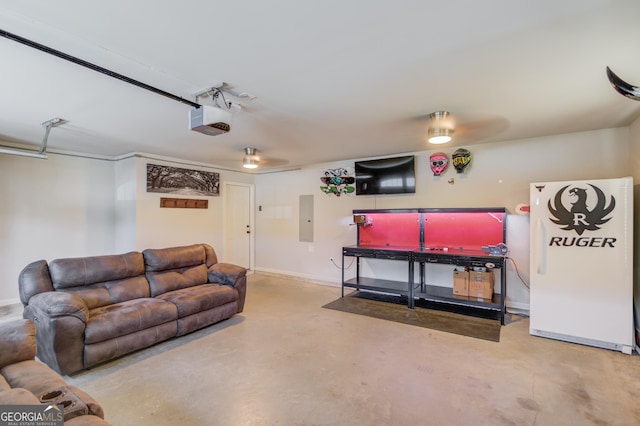 living room featuring electric panel, baseboards, a garage, and concrete flooring