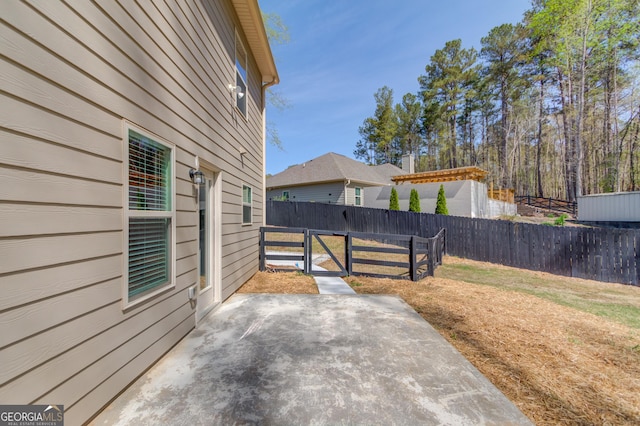 view of patio with a gate and fence
