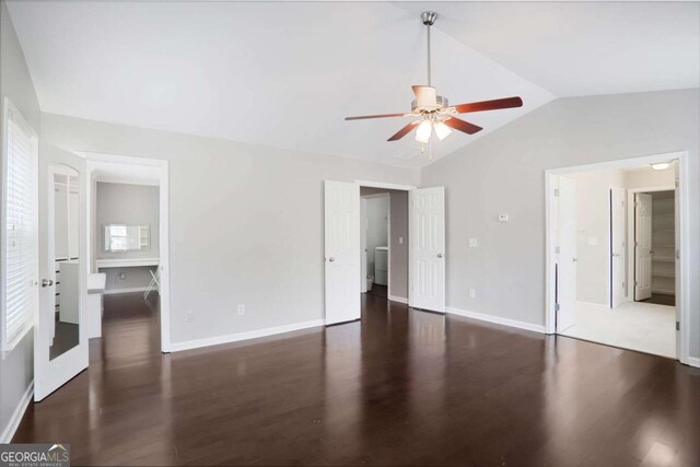 unfurnished bedroom with baseboards, wood finished floors, and vaulted ceiling