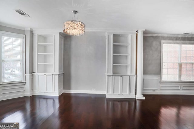unfurnished dining area featuring plenty of natural light, built in features, and ornate columns