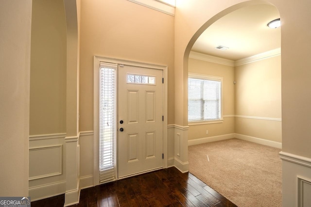 132 Windmeadow Way, Fayetteville, GA 30214 - foyer entrance with wainscoting, visible vents, arched walkways, ornamental molding, and dark wood-type flooring